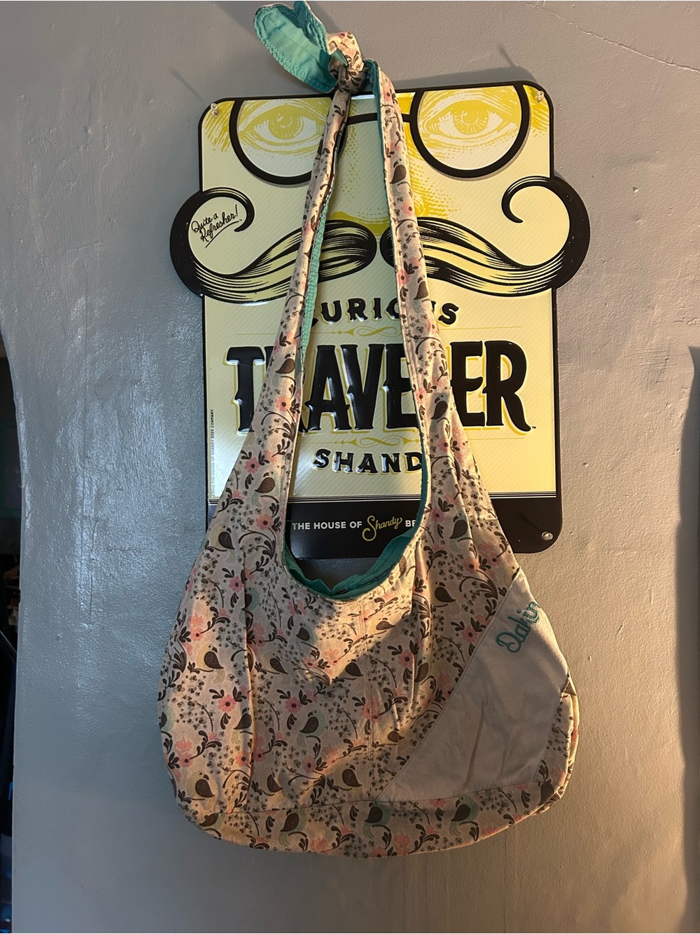 Dakine Floral Sling Hobo Bag in tan with Teal and pink Accents